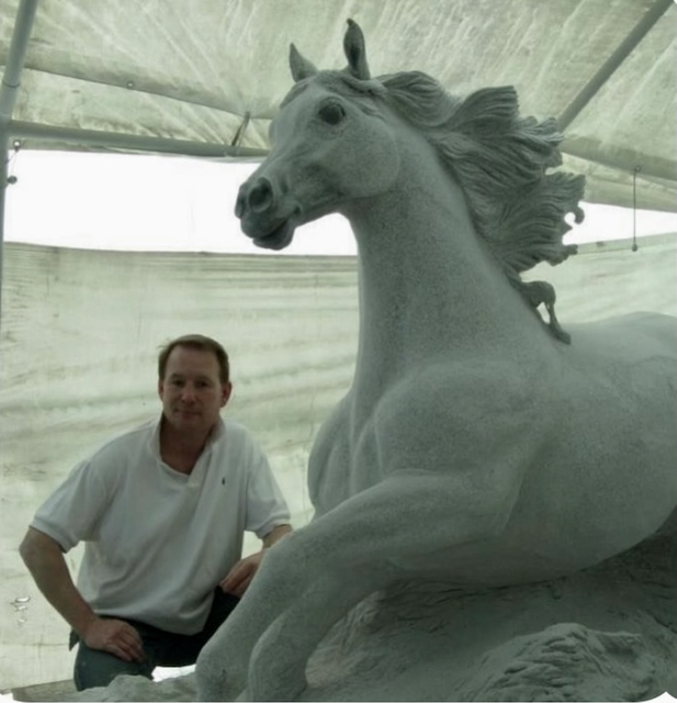 Steve Dean, Multimedia artist, working on the granite stallion in 2008.